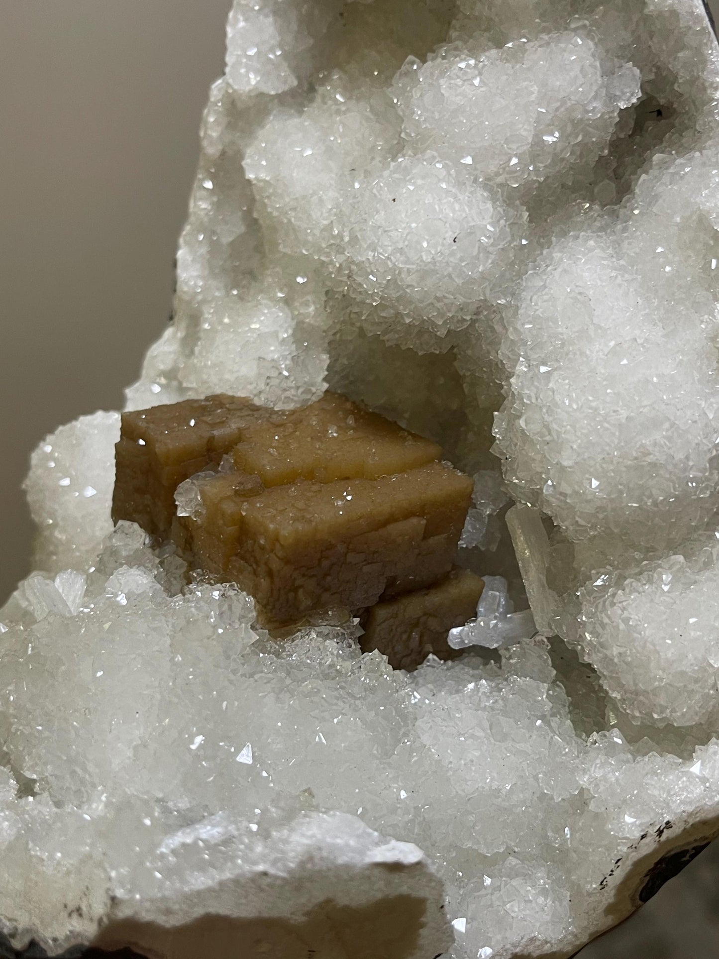 rare find. brown cubical calcite crystal with stilbite petals on quartz matrix