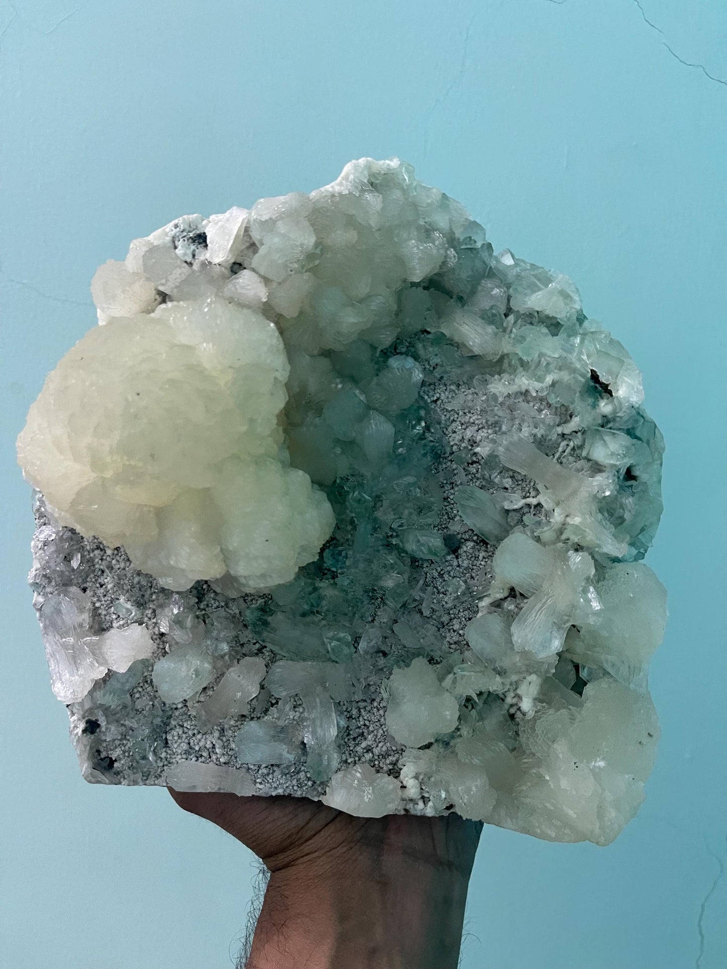 pointed light green apophyllite crystal with stilbite