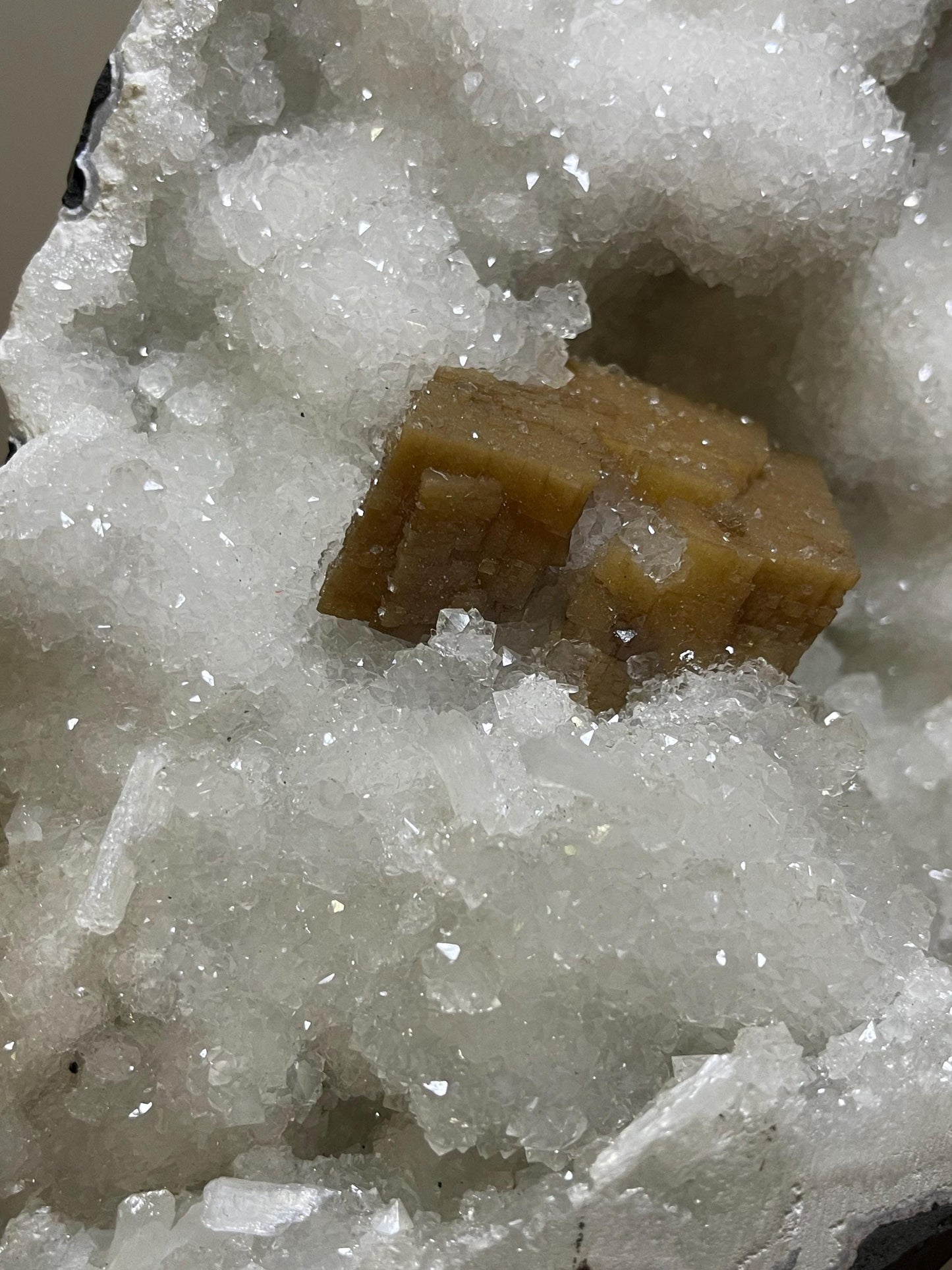 rare find. brown cubical calcite crystal with stilbite petals on quartz matrix