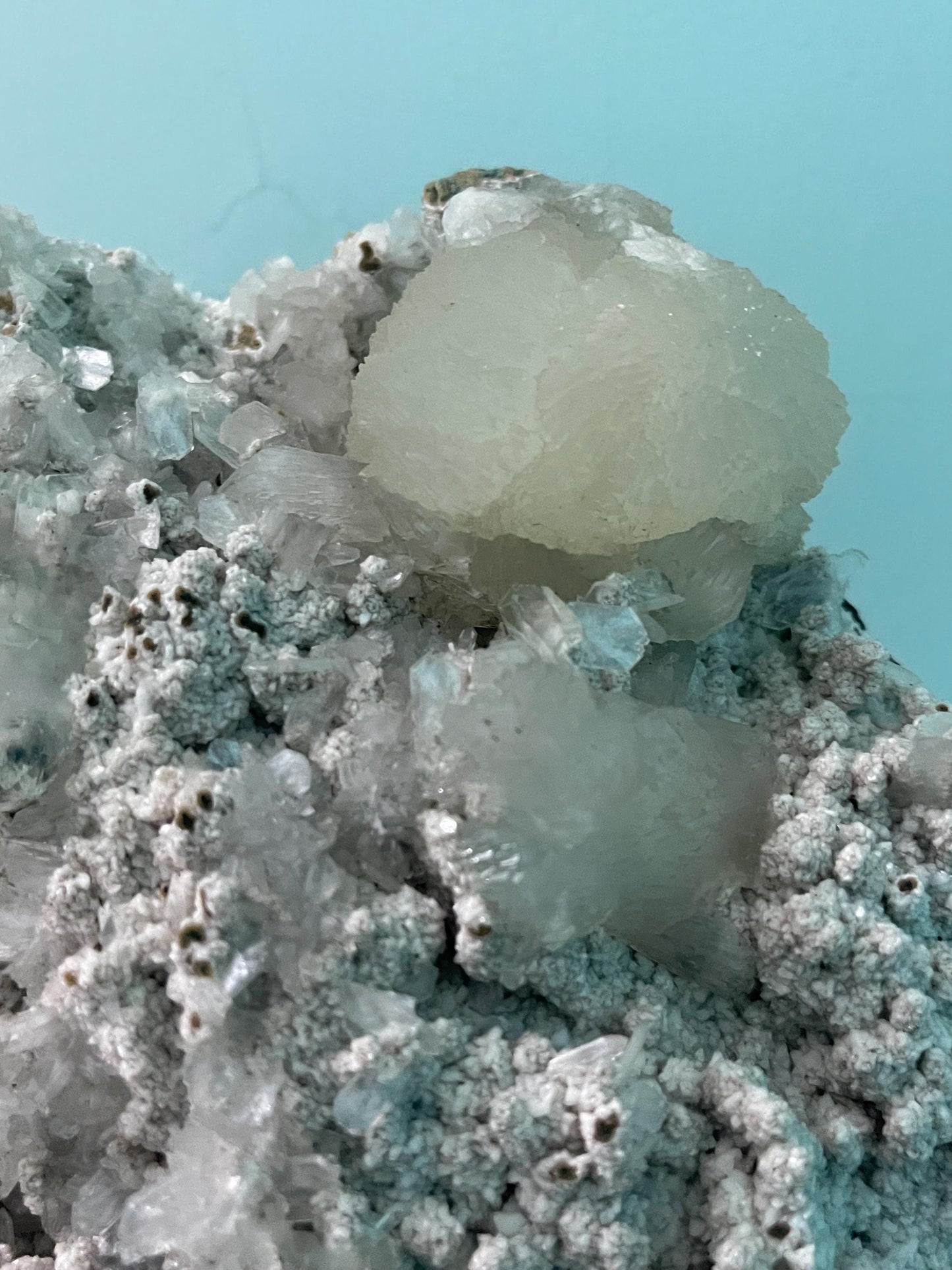 light green apophyllite crystal flower on white chalcedony matrix with stilbite