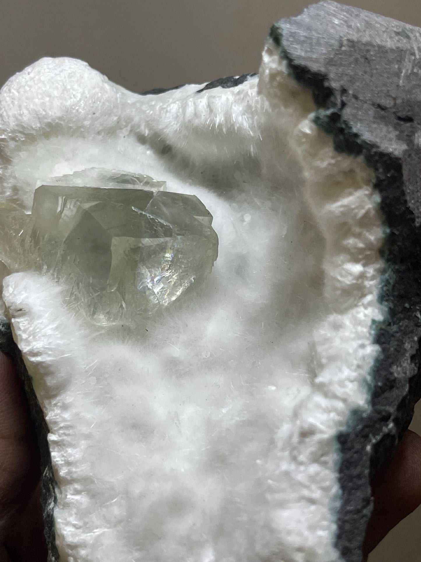 rare find, transparent calcite crystal on okenite matrix