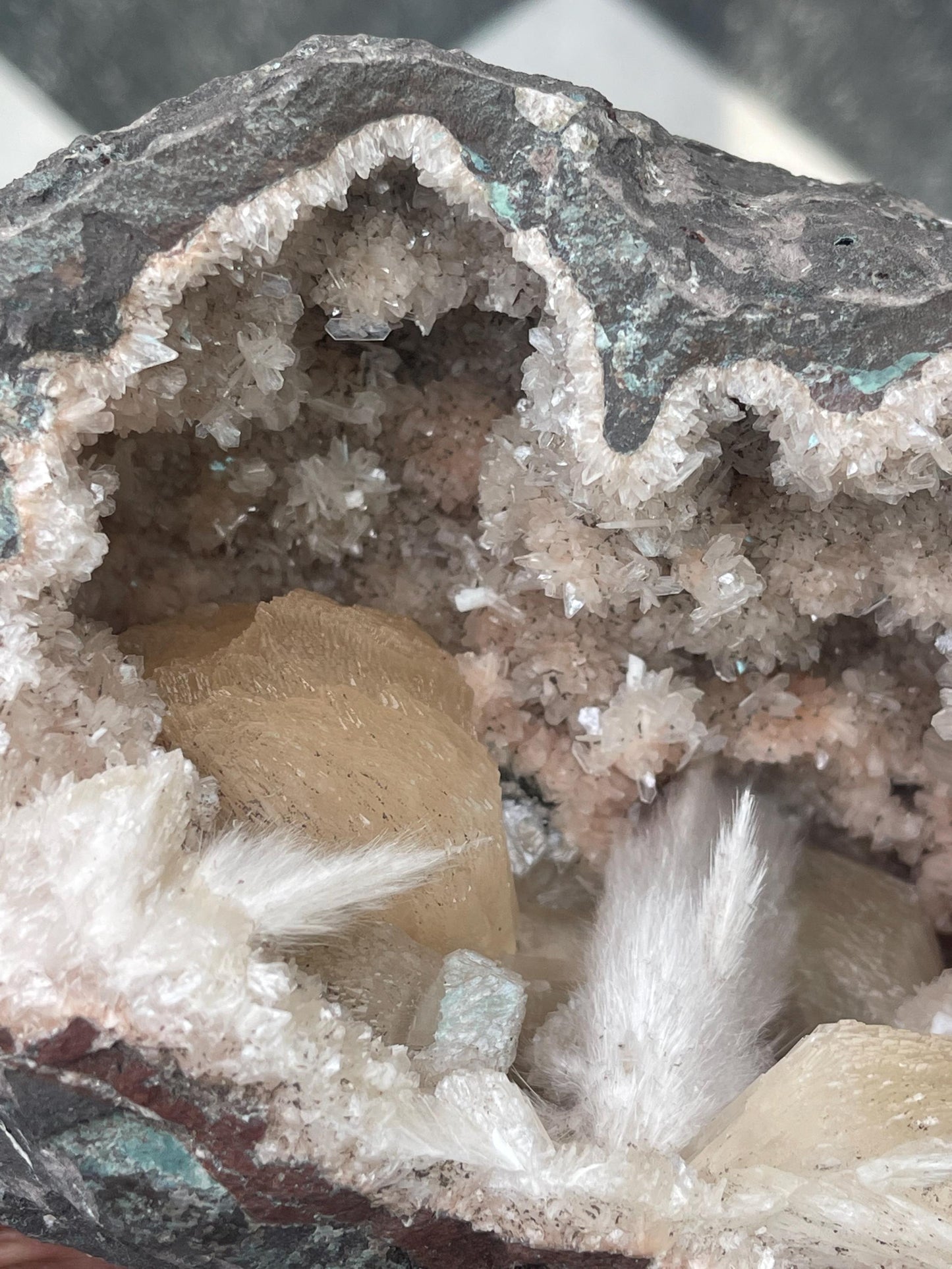Combination of Scolecite sprays and peach stilbites inside heulandite geode