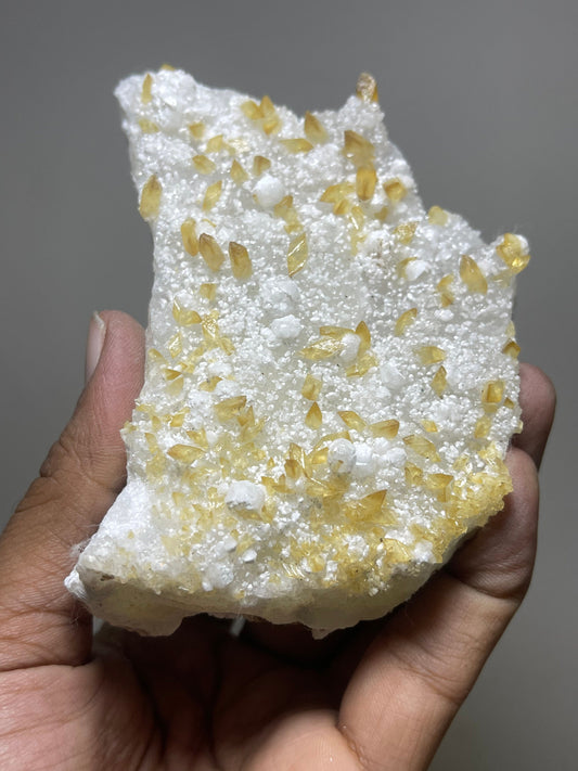 Shiney golden calcite crystal on chalcedony base