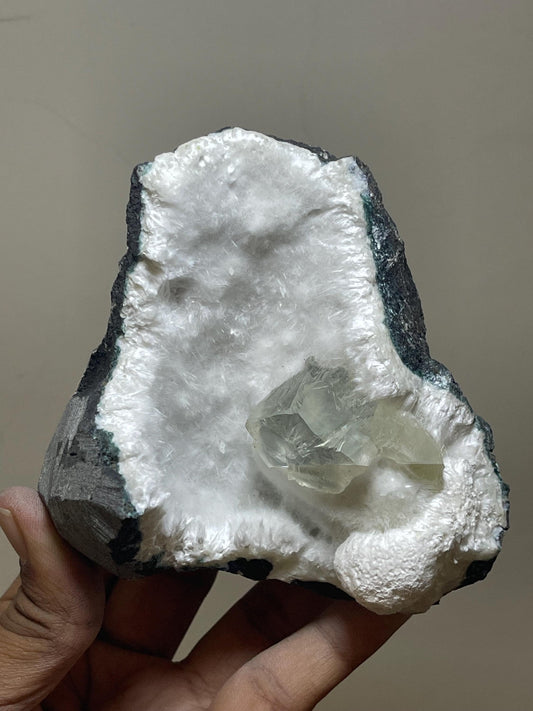rare find, transparent calcite crystal on okenite matrix