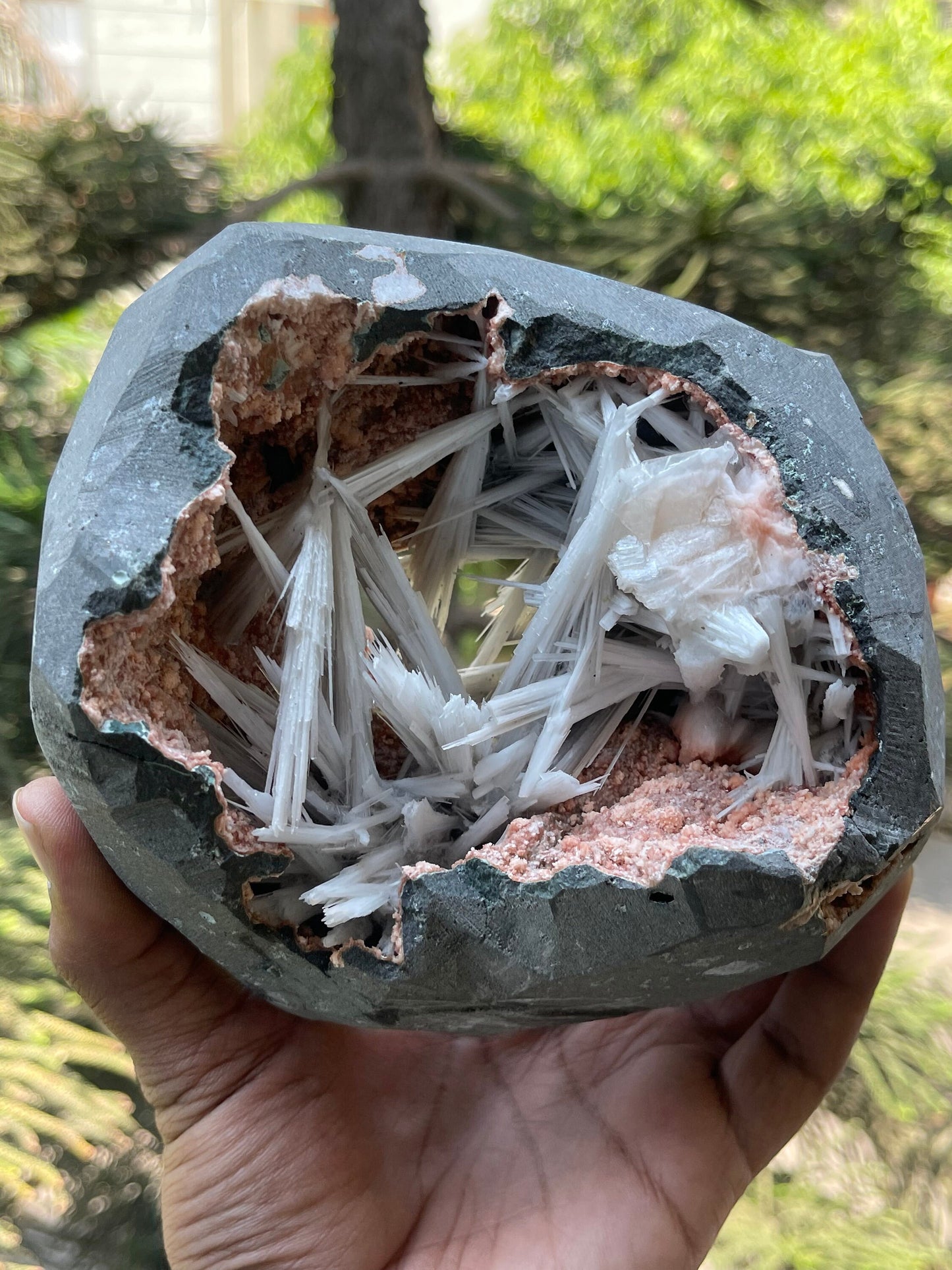 Scolecite spray inside orange heulandite geode