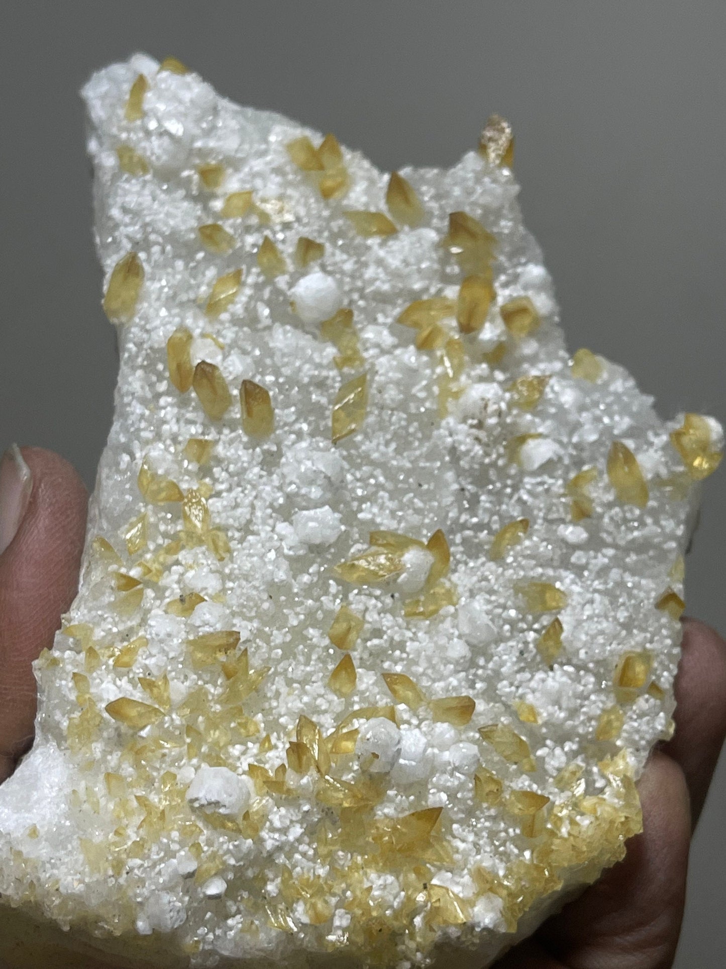 Shiney golden calcite crystal on chalcedony base