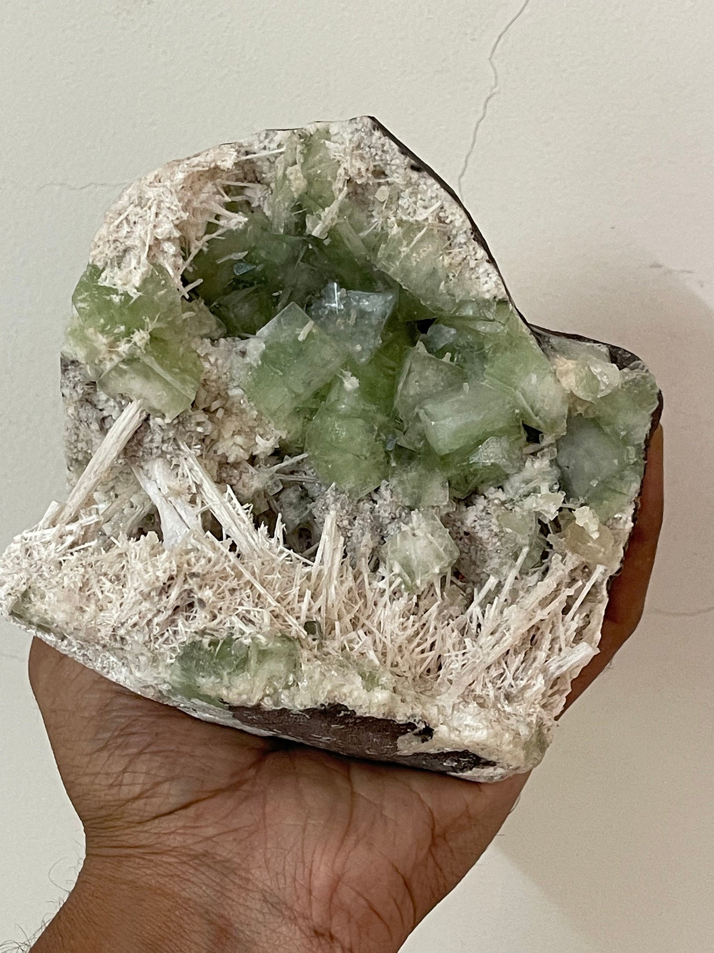 Green apophyllite crystal with scolecite sprays base geode