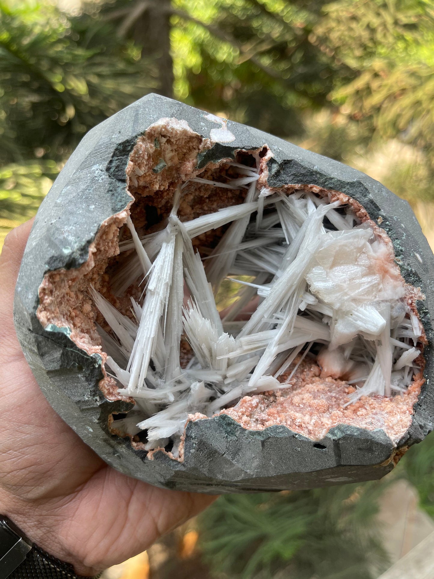 Scolecite spray inside orange heulandite geode