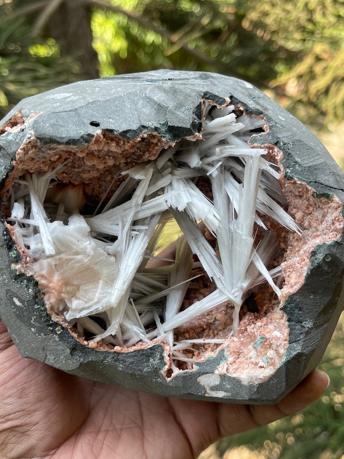 Scolecite spray inside orange heulandite geode
