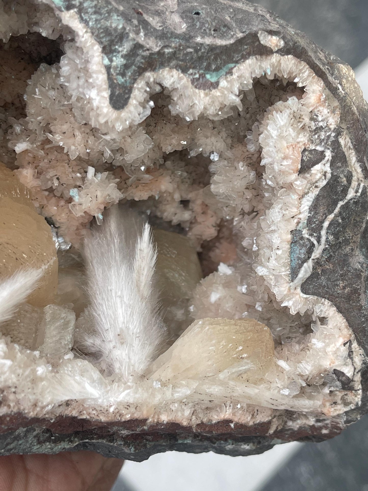 Combination of Scolecite sprays and peach stilbites inside heulandite geode