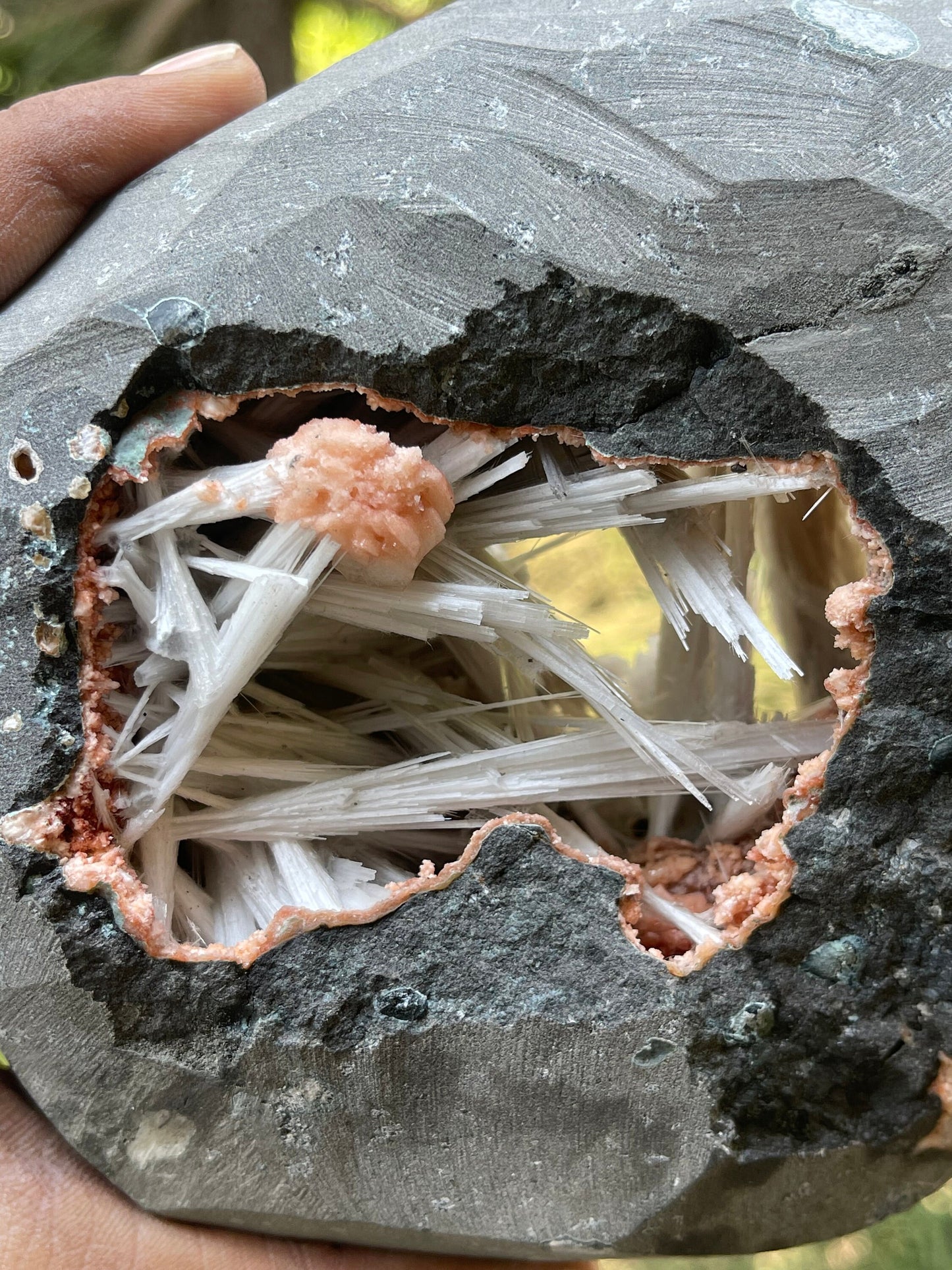 Scolecite spray inside orange heulandite geode