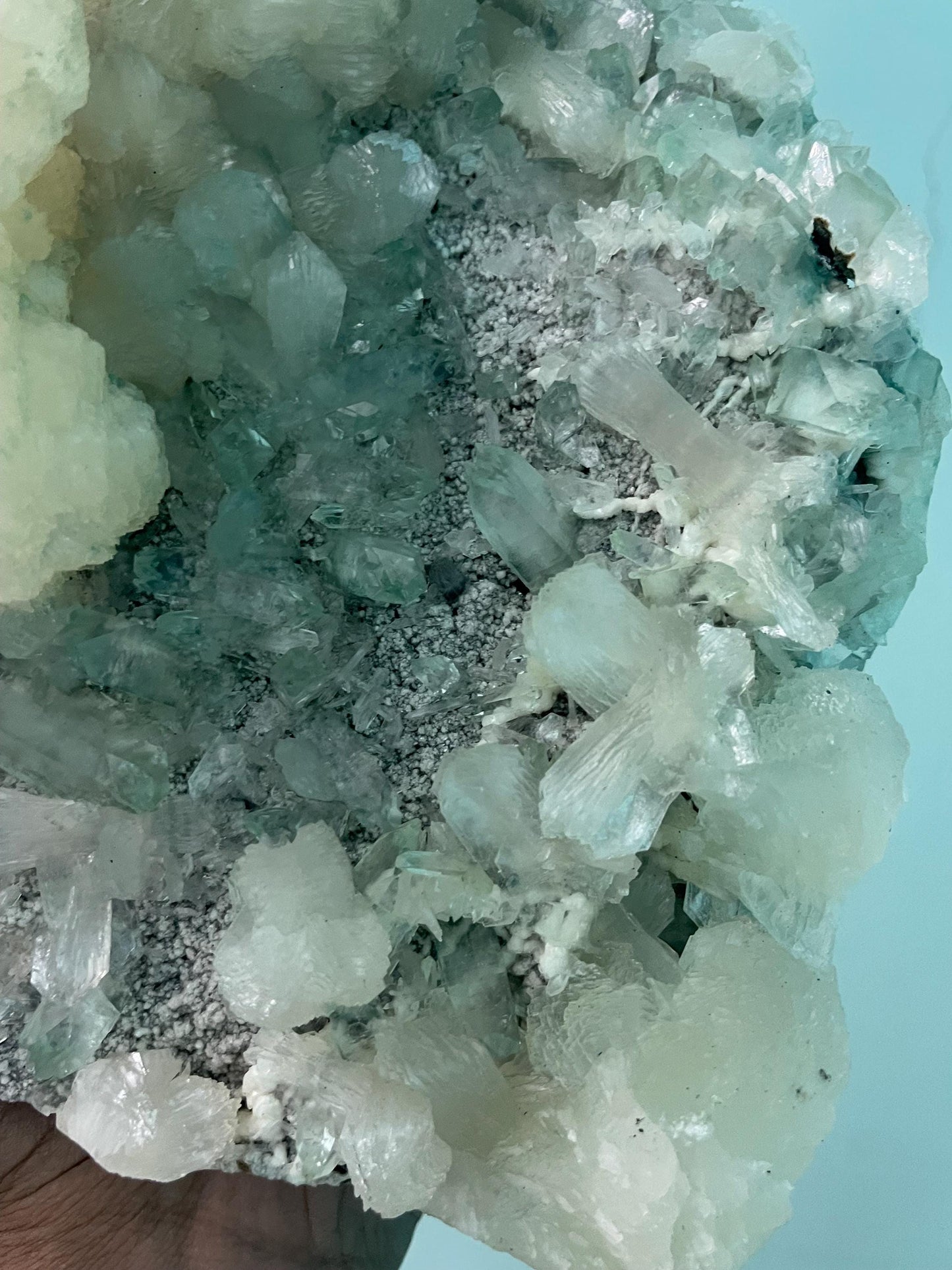 pointed light green apophyllite crystal with stilbite