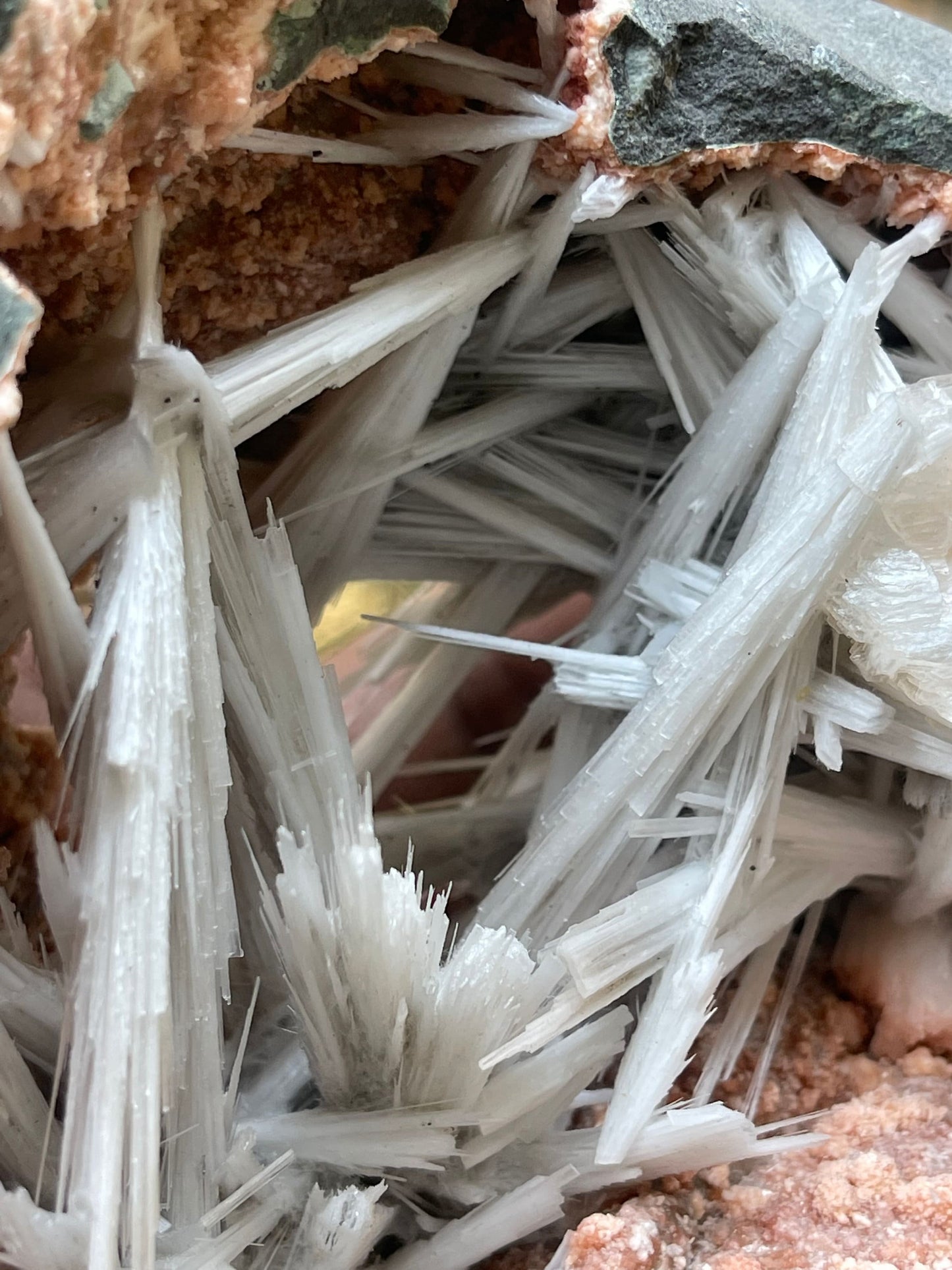 Scolecite spray inside orange heulandite geode