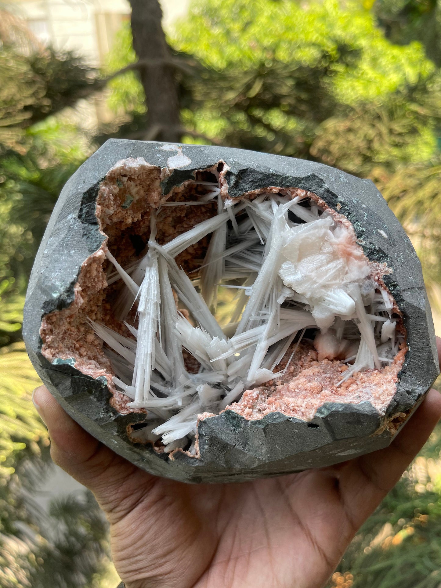 Scolecite spray inside orange heulandite geode