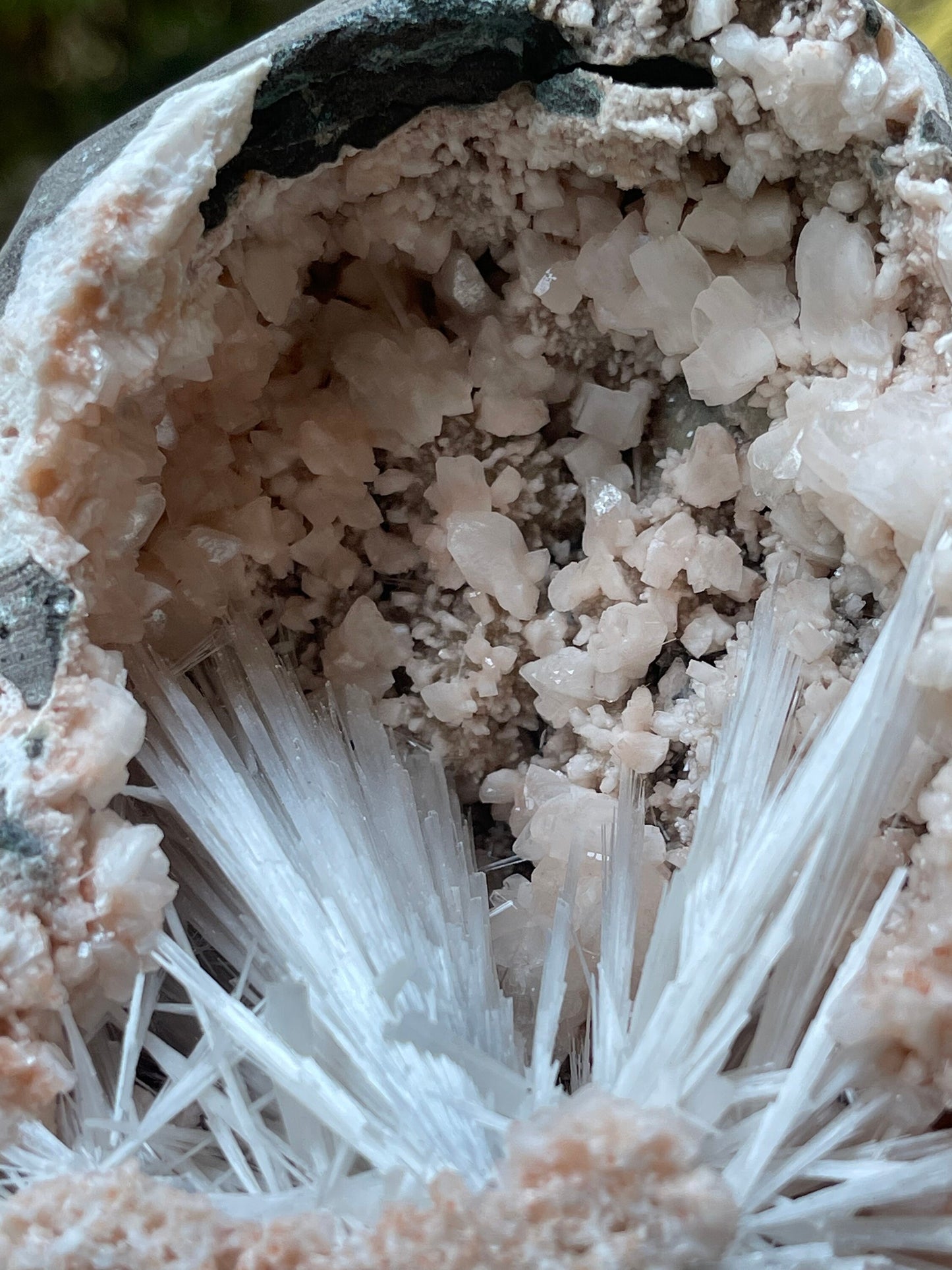 Scolecite spray with orange heulandite crystals inside geode natural specimen