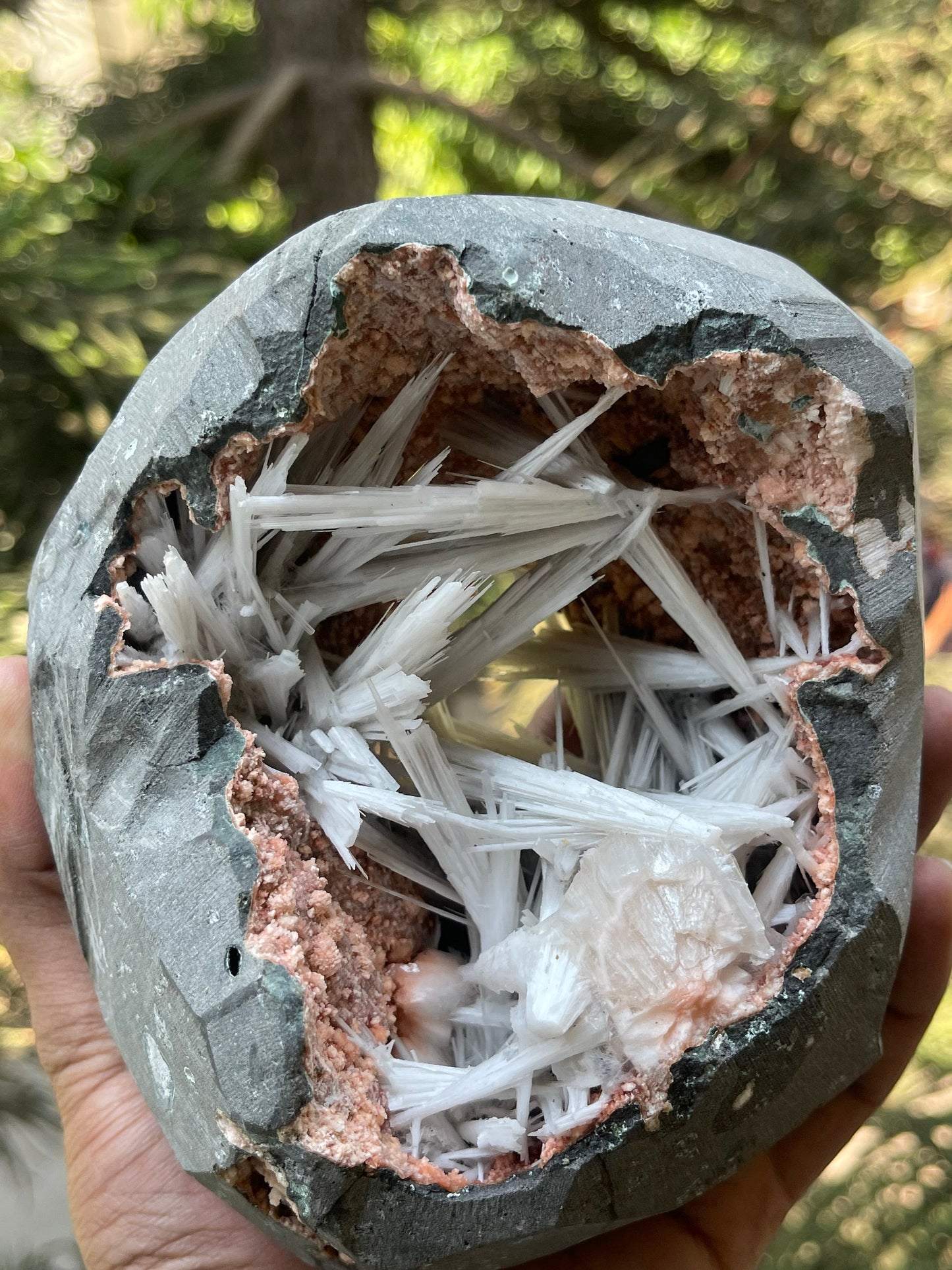 Scolecite spray inside orange heulandite geode