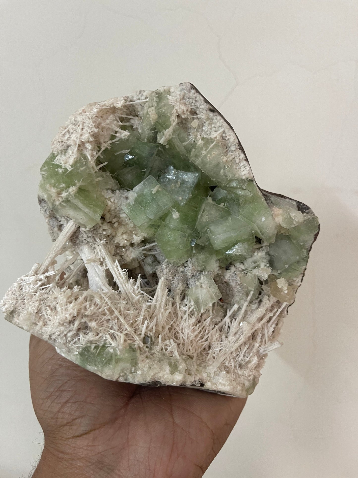 Green apophyllite crystal with scolecite sprays base geode