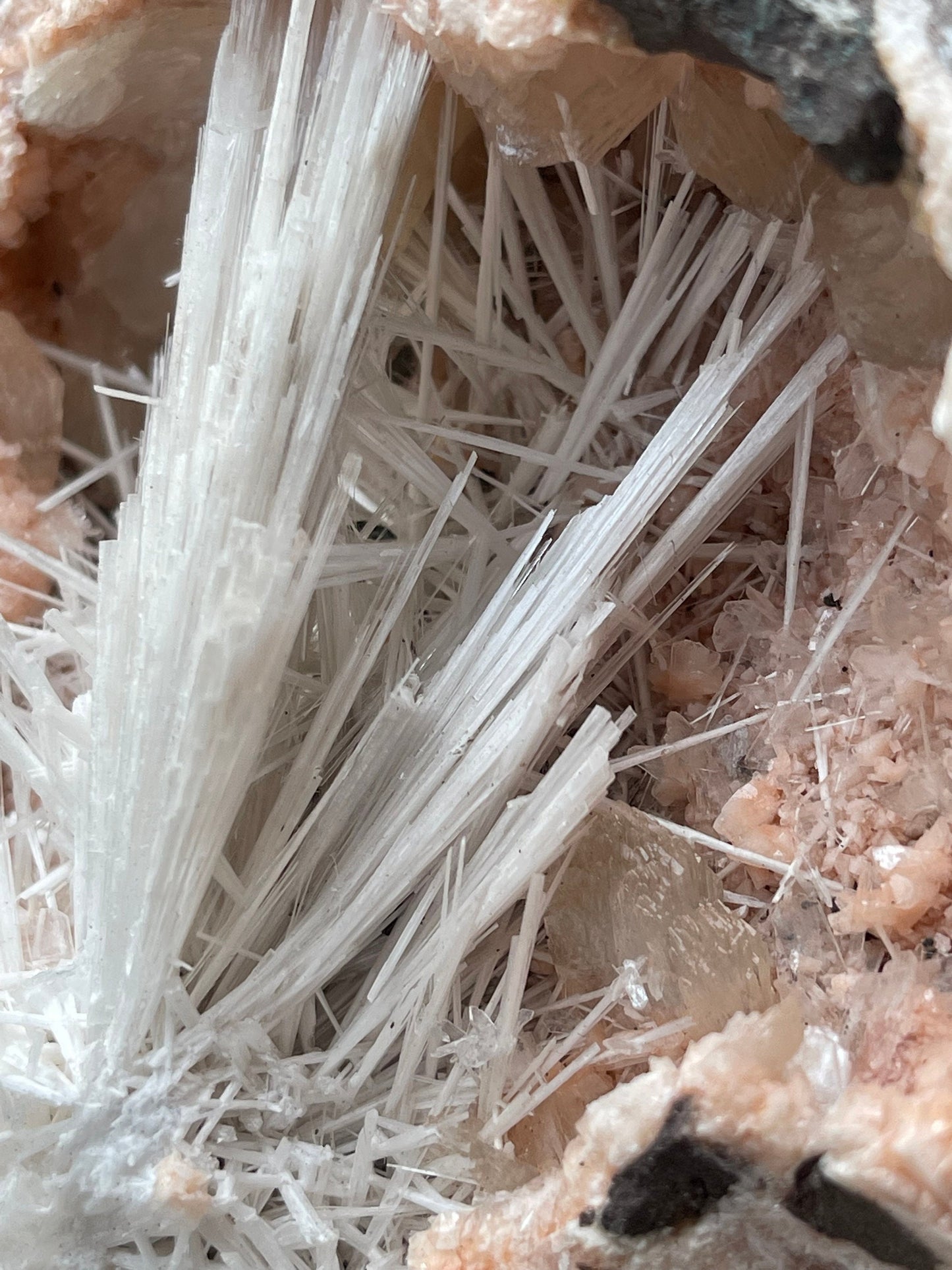 Scolecite flower inside orange haulandite geode