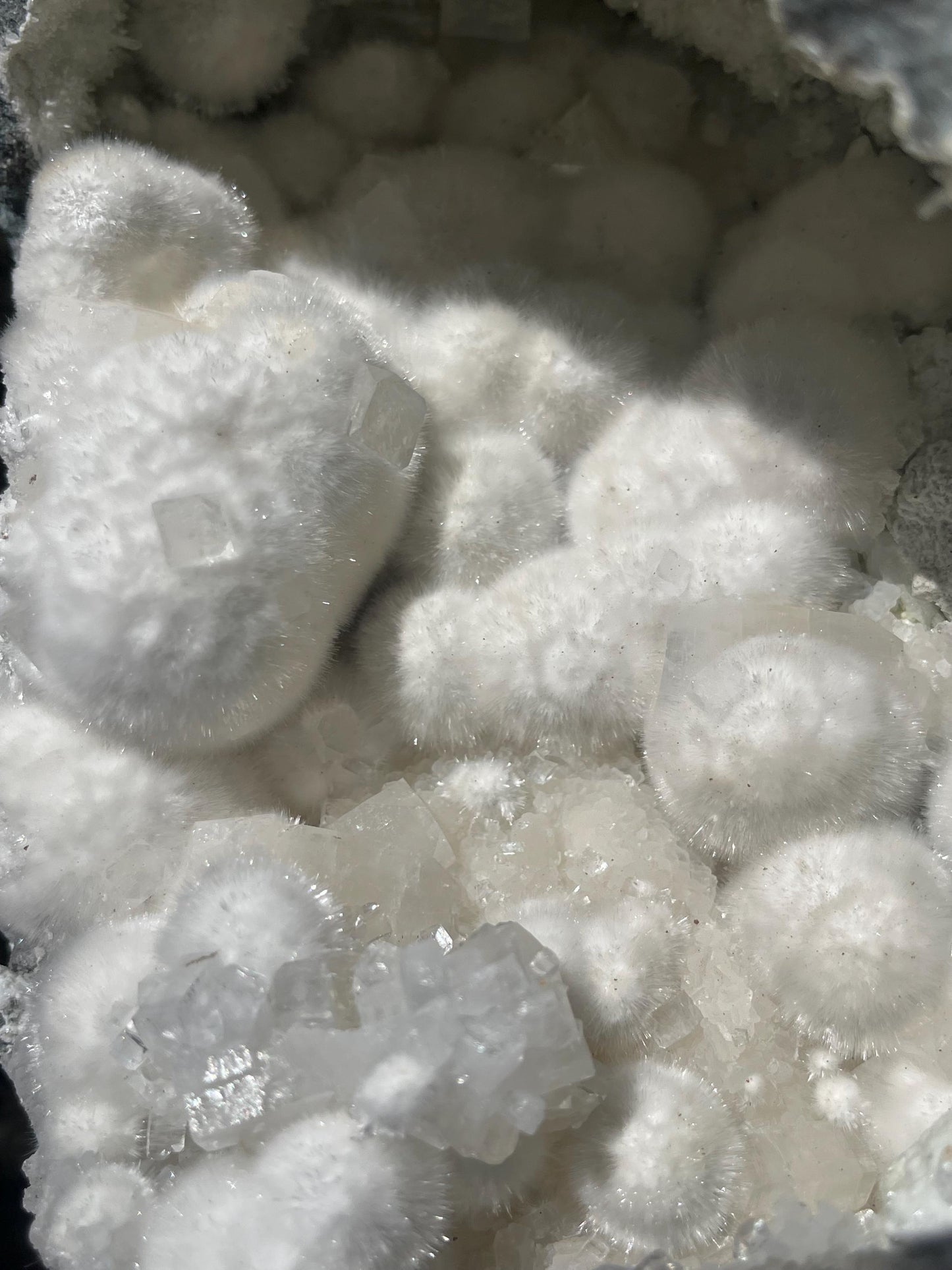 okenite big puffs balls on apophyllite inside geode