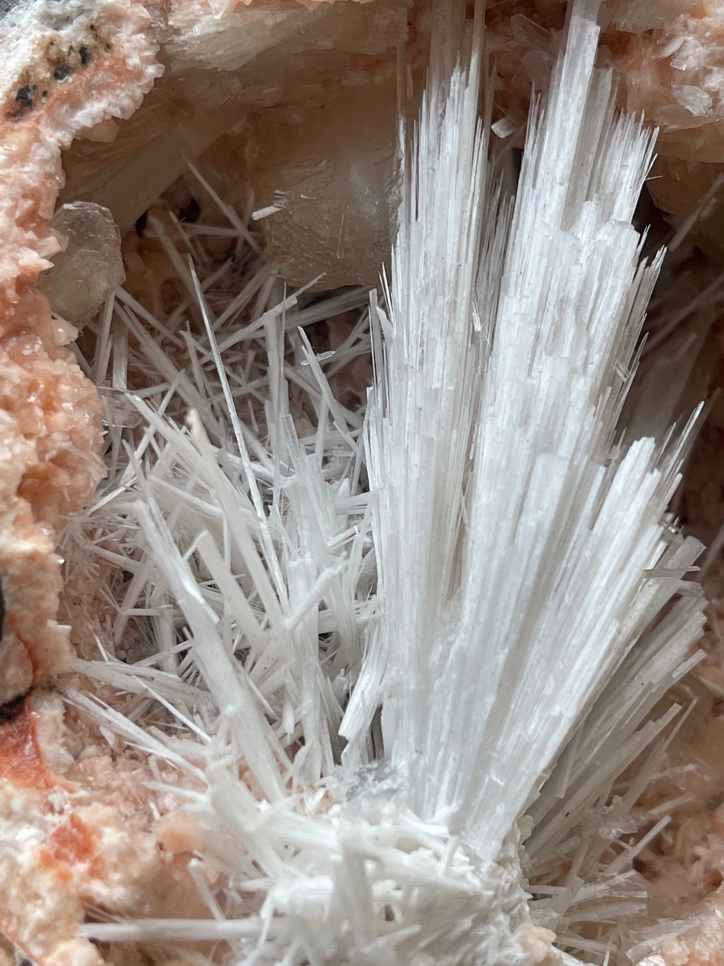 Scolecite flower inside orange haulandite geode
