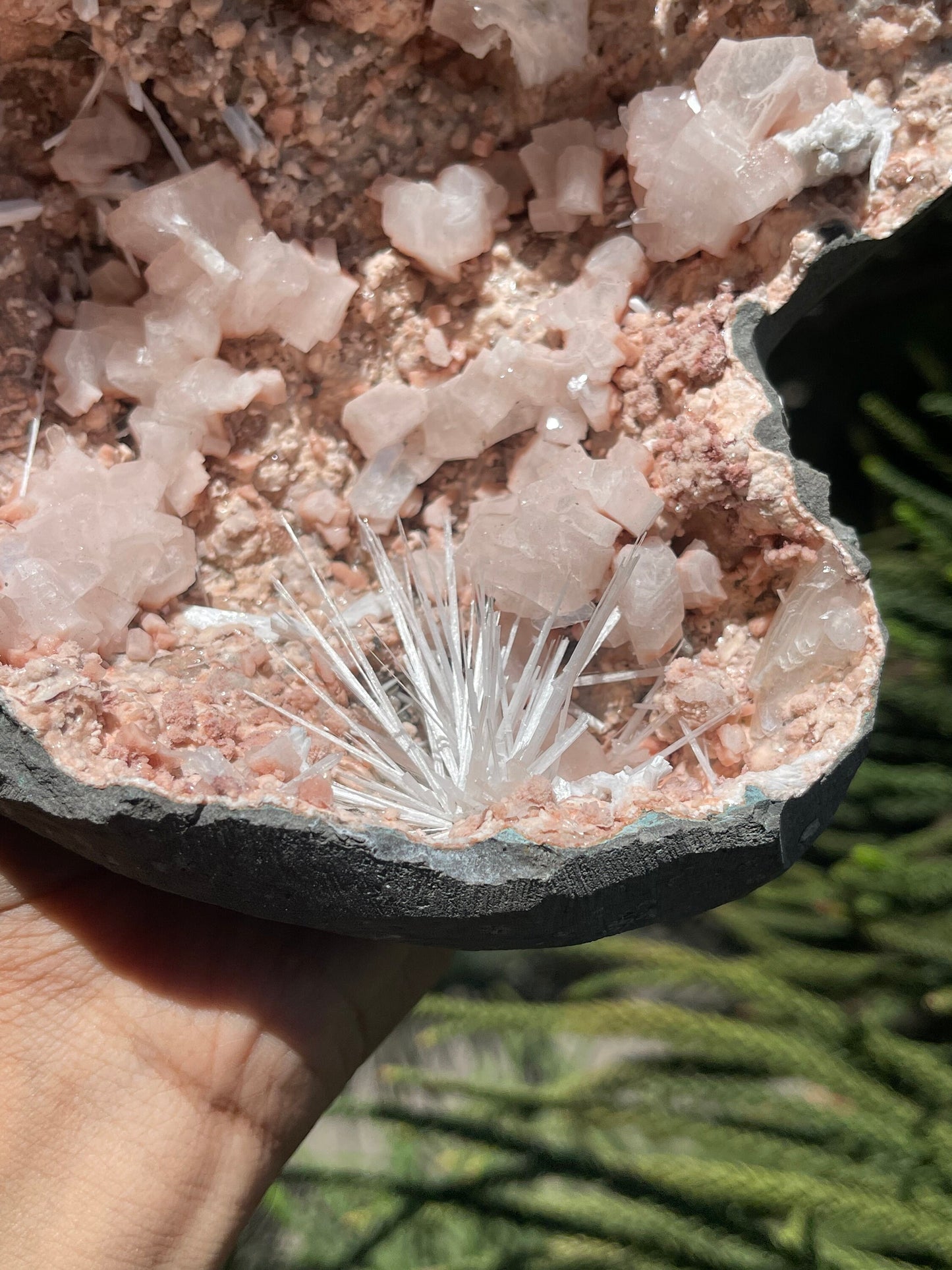Scolecite spray inside orange heulandite geode