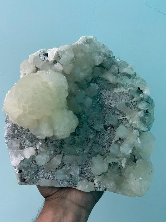 pointed light green apophyllite crystal with stilbite