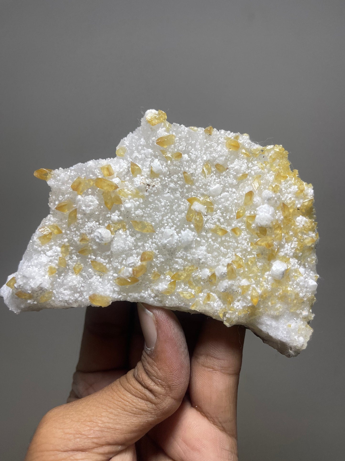 Shiney golden calcite crystal on chalcedony base