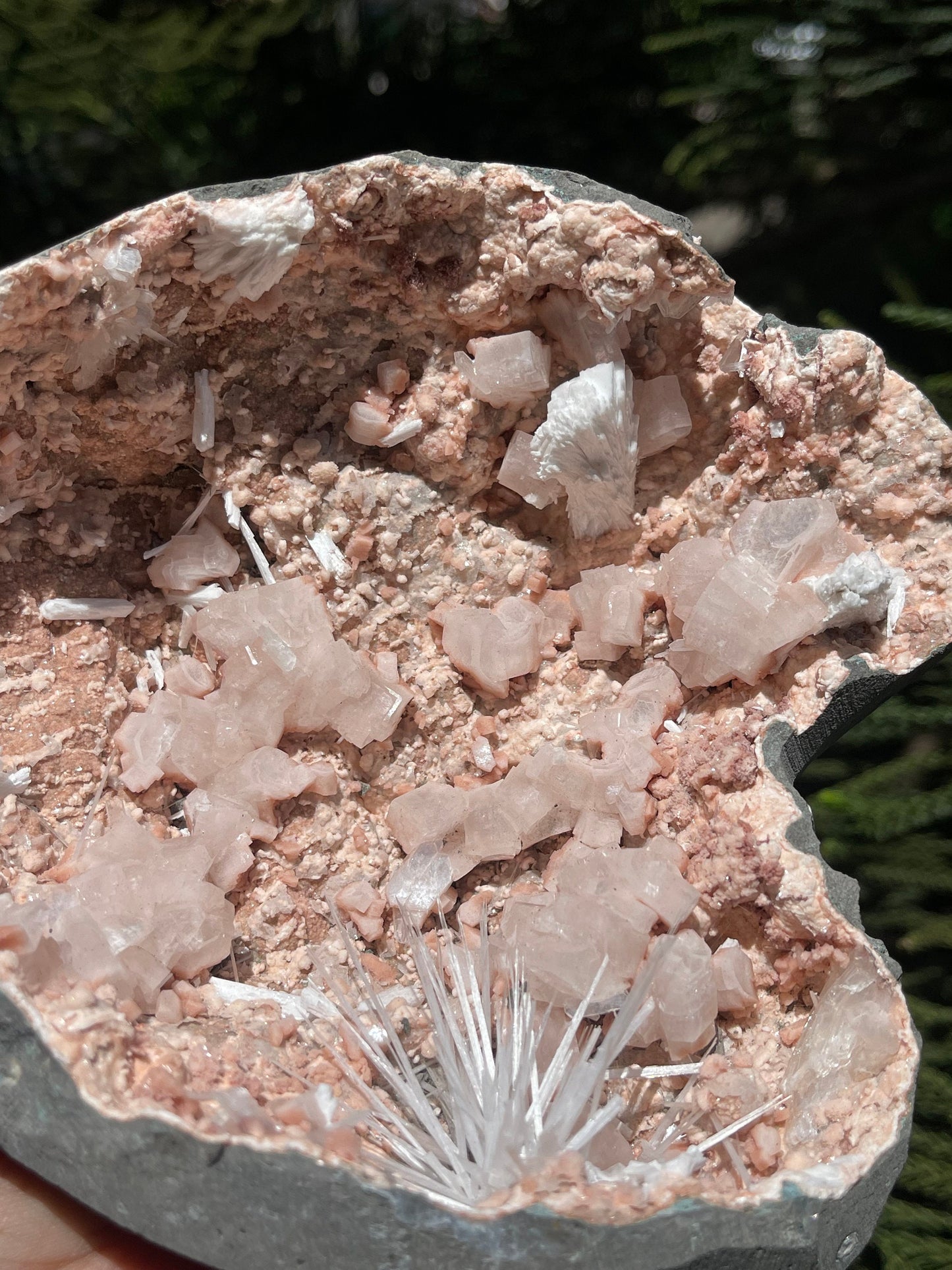 Scolecite spray inside orange heulandite geode