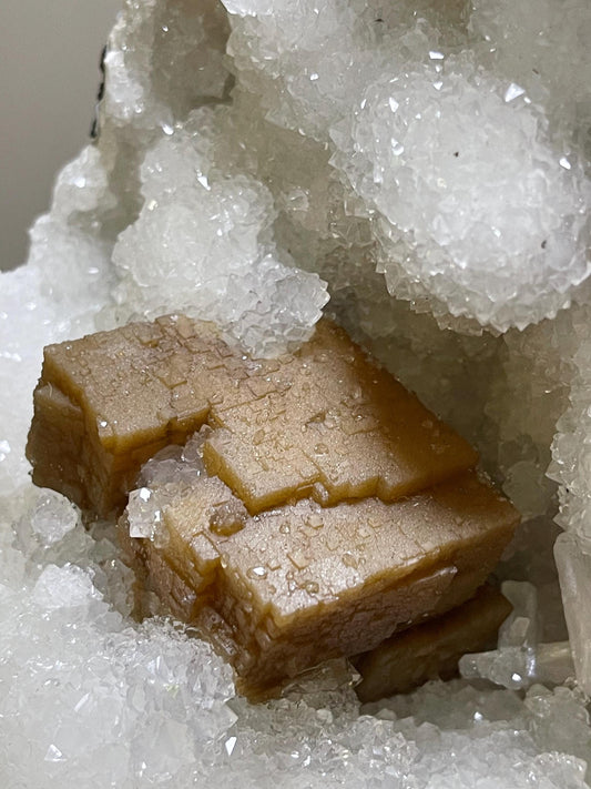 rare find. brown cubical calcite crystal with stilbite petals on quartz matrix