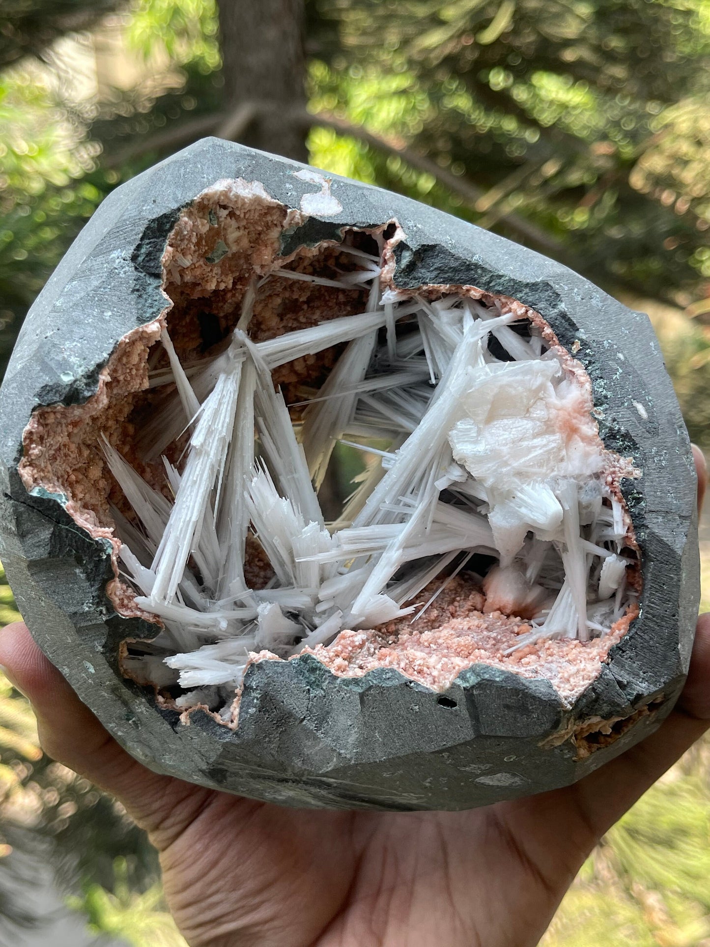 Scolecite spray inside orange heulandite geode